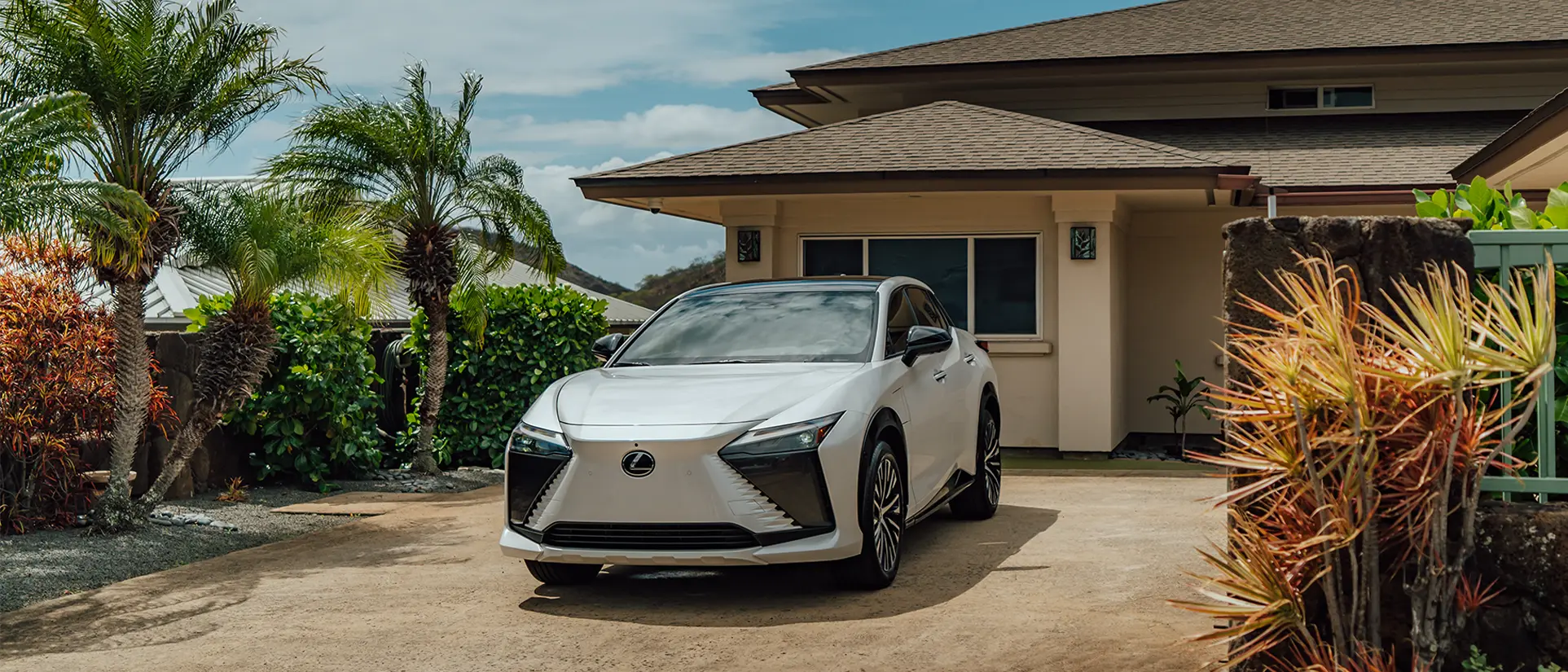 Lexus RZ 450e Luxury shown in Eminent White Pearl in driveway